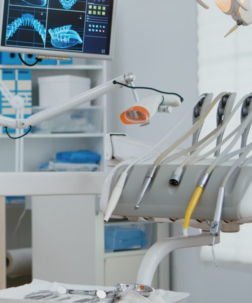 Interior of modern dental office in hospital with dentistry orthodontic furniture. Zoom in shot of professional tooth instrument. Workplace cabinet for orthodontist health, care treatment