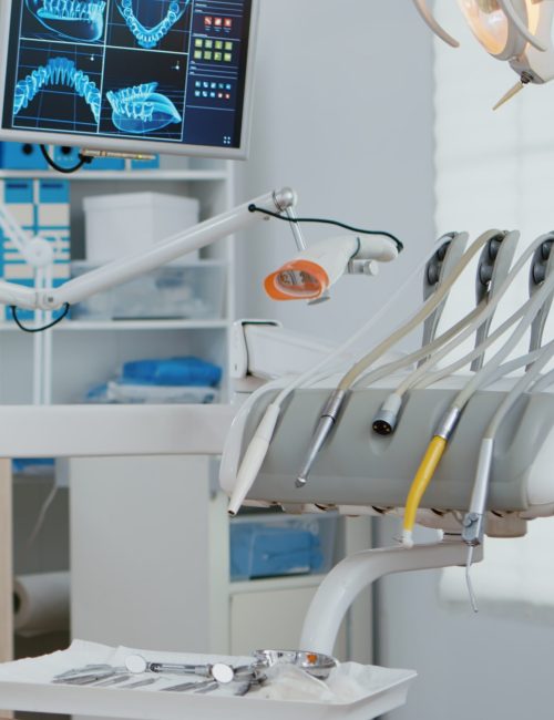 Interior of modern dental office in hospital with dentistry orthodontic furniture. Zoom in shot of professional tooth instrument. Workplace cabinet for orthodontist health, care treatment